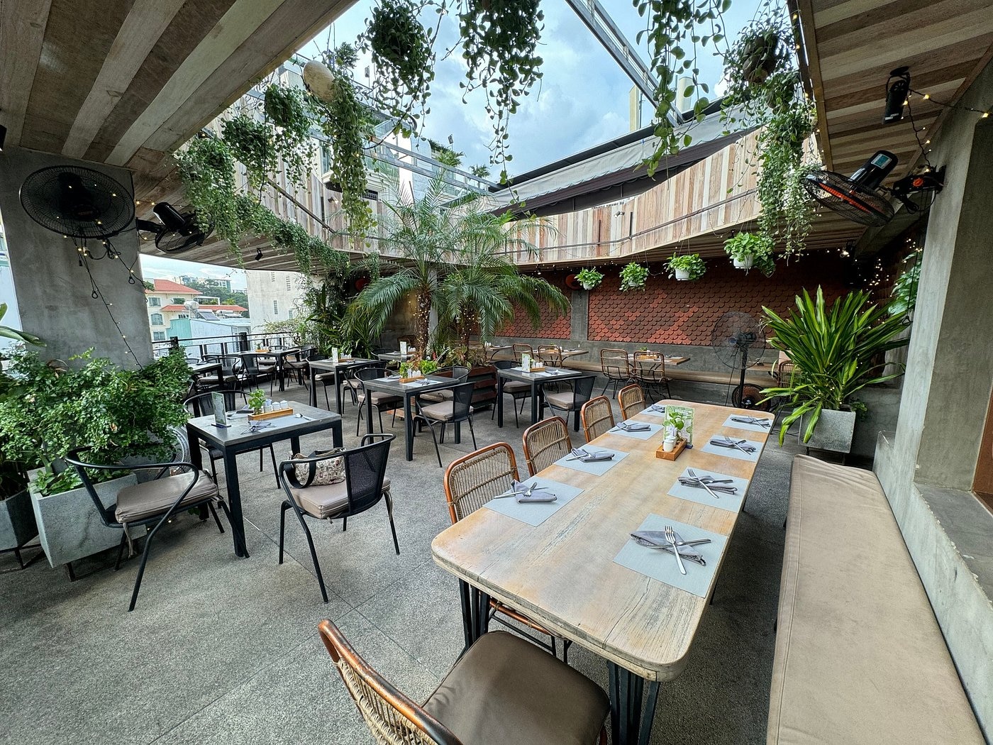 Cityscape views from the rooftop, paired with warm lighting and greenery, create a romantic yet modern setting